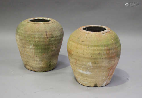 Two Chinese terracotta storage jars, probably Neolithic period, each of ribbed ovoid form, heights