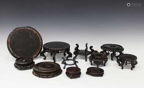 A collection of twenty-two mostly Chinese circular wooden stands, late Qing dynasty and later, of