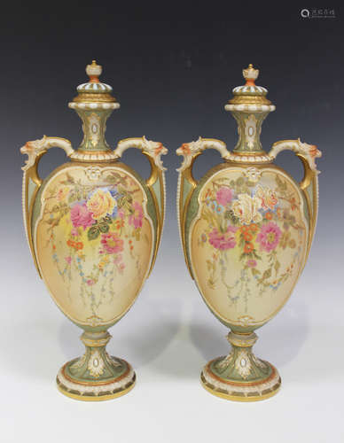 A pair of Royal Worcester blush ivory two-handled vases and covers, circa 1909, the ovoid bodies