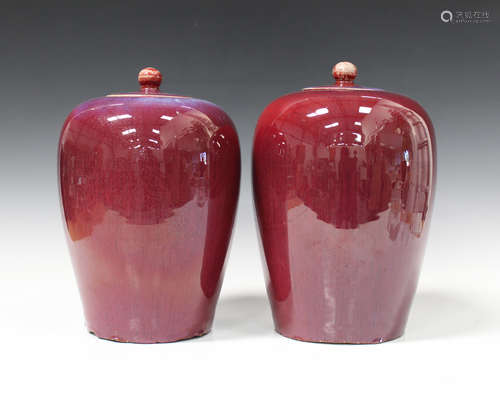 A pair of Chinese flambé glazed porcelain jars and covers, late Qing dynasty, each shouldered