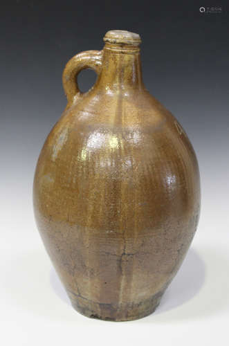 A large stoneware salt glazed Bellarmine style jug, late 17th/early 18th century, of typical pear