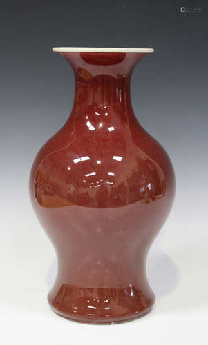 A Chinese sang-de-boeuf glazed porcelain vase, late Qing dynasty, of baluster form with flared neck,