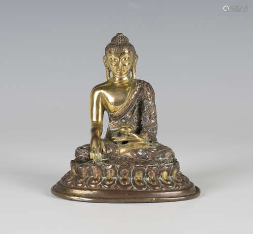 A Sino-Tibetan gilt copper alloy figure of Buddha, Qing dynasty, modelled seated in dhyanasana