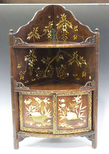 A Japanese inlaid and lacquered wood hanging bowfront corner cabinet, Meiji period, the arched