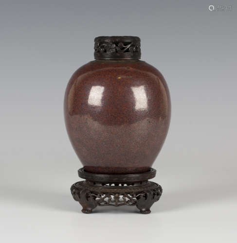A Chinese iron rust glazed porcelain ovoid jar, Qing dynasty, covered in a lustrous reddish-brown