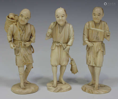 A group of three Japanese carved sectional ivory okimono figures of male workers, Meiji period, each