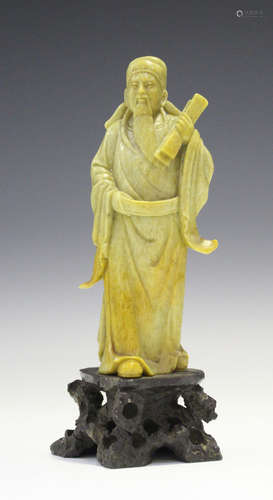 A Chinese carved soapstone figure of a sage, early 20th century, modelled standing on a rocky