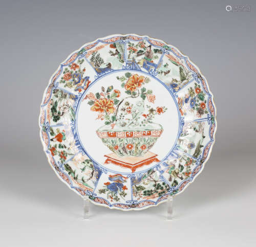 A Chinese famille verte export porcelain fluted circular dish, Kangxi period, the central panel