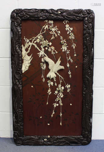 A Japanese inlaid lacquer panel, Meiji/Taisho period, decorated in ivory and bone with a bird