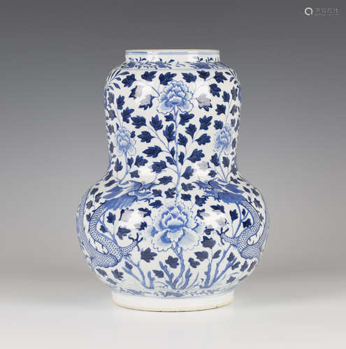 A Chinese blue and white porcelain vase, mark of Kangxi but late 19th century, of swollen gourd