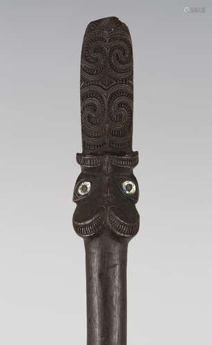 A Maori dense hardwood taiaha, probably late 19th century, the finial finely carved in the form of