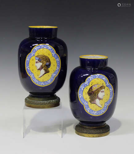 A pair of Vierzon Jean French faience vases, 1880s, the blue glazed barrel shaped bodies reserved