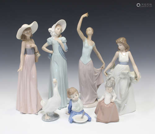 Thirteen Nao porcelain figures, including seven ladies, a ballerina, a baby and two swans (minor