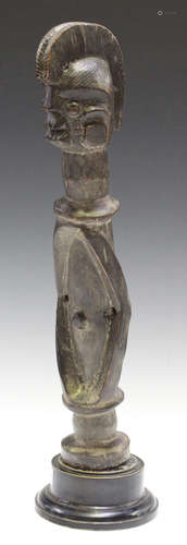 A Mumuye carved hardwood ancestor figure, Nigeria, modelled with a crest and birdlike features,