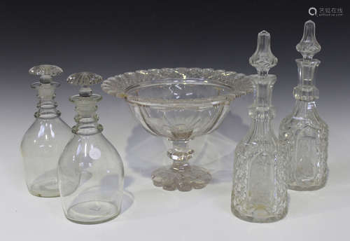 A pair of triple ring neck plain decanters and stoppers, 19th century, fitted with moulded