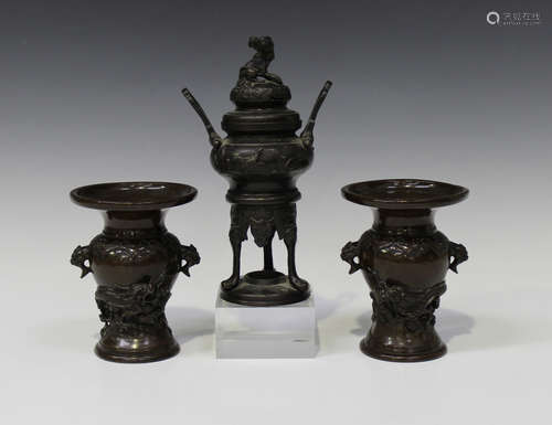 A pair of Japanese brown patinated bronze vases, Meiji period, each baluster body cast in relief