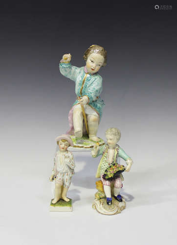 A pottery figure of a boy, 19th century, modelled on a naturalistic base wearing a long, pale