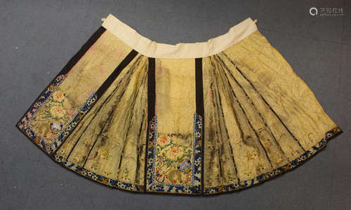 A Chinese silk embroidered apron skirt, late Qing dynasty, worked in gilt and polychrome threads