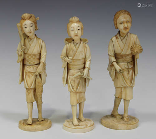 A group of three Japanese carved sectional ivory okimono figures of female workers, Meiji period,