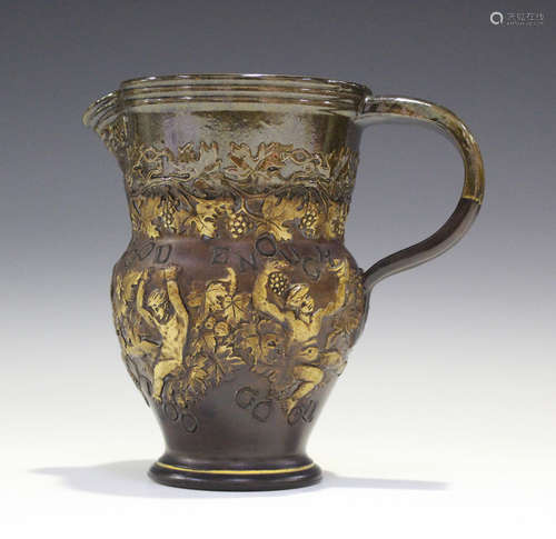 A Royal Doulton stoneware motto jug, circa 1900, the brown glazed body sprigged with Bacchanalian