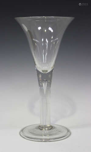 A large plain stem wine glass, mid-18th century, the drawn trumpet bowl raised on a teared plain