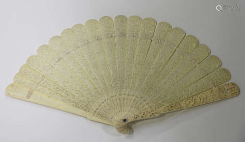 A Chinese Canton export ivory brisé fan, late 19th century, the pair of guards carved in relief with