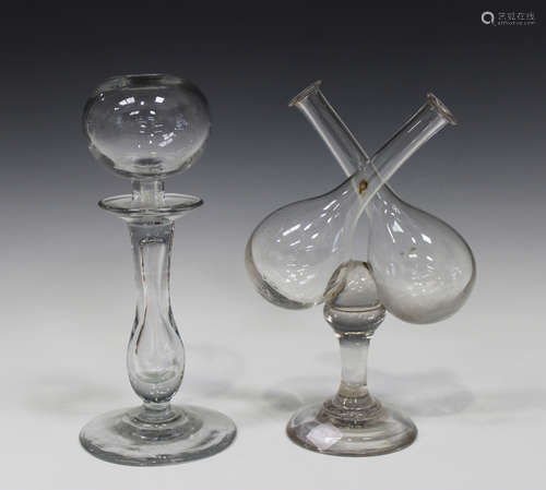 A glass 'lacemaker's' oil lamp, 19th century, with globular reservoir on a teared baluster stem