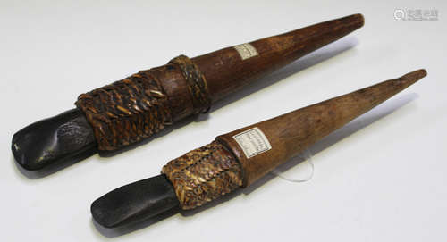 Two New Guinea stone axes, mounted onto wooden handles with rattan binding, both bearing 'F.S. Clark