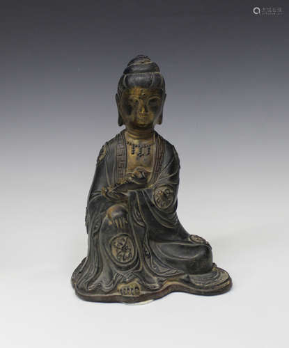 A Chinese Ming style bronze figure of a seated bodhisattva, Qing dynasty, modelled seated holding