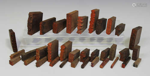 A large collection of Japanese wooden printing blocks, all with carved characters (approx 300 in