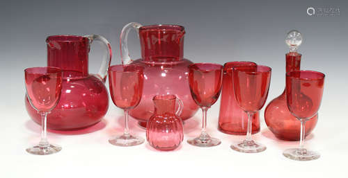 A small group of cranberry glassware, 19th and 20th century, including two water jugs, a decanter