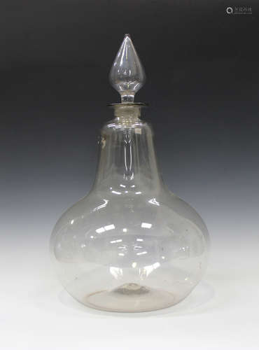 A large clear glass apothecary jar and stopper, late 19th/early 20th century, the pear shaped body