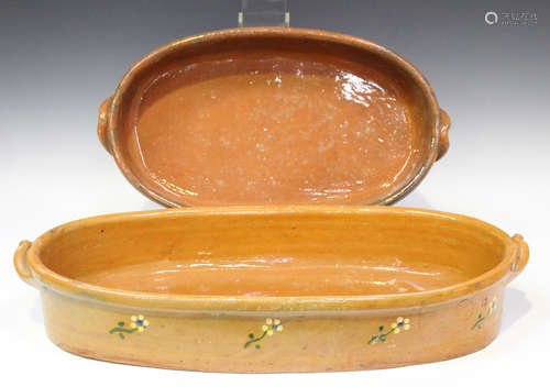 A graduated pair of Portuguese Mafra terracotta pottery baking dishes, early 20th century, of oval