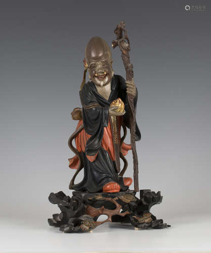 A Chinese lacquered carved wood figure of Shoulao, probably Fuzhou (Foochow), late Qing dynasty,