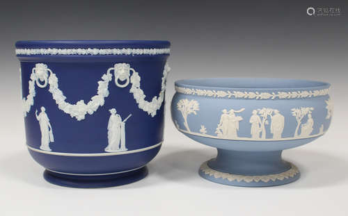 A Wedgwood dark blue jasperware jardinière, circa 1900, typically sprigged in white with classical