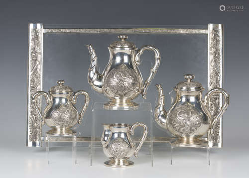 A Chinese silver four-piece tea set and tray, early 20th century, comprising teapot and cover, hot