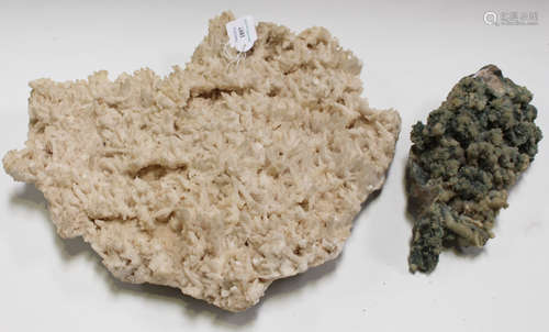 A large white mineral formation, width 42cm, and a similar green specimen, width 27cm.Buyer’s