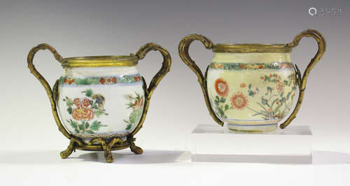 A pair of Chinese famille verte porcelain pots, Kangxi period, with later European ormolu mounts,