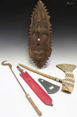 A Papua New Guinea ceremonial axe, mid-20th century, the carved green stone head bound in woven