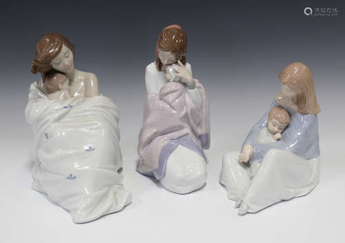 Three Nao porcelain figure groups, comprising Cosy Slumber, The Greatest Bond and a mother and baby,