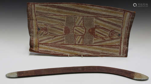 An Australian carved hardwood boomerang, length 68cm, together with an Australian Aboriginal bark