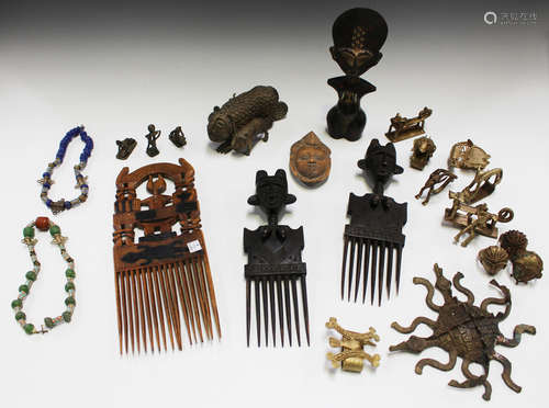 A group of African collectors' items, including a pair of carved wooden combs, another larger