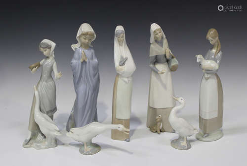 Three Lladro porcelain figures, including a girl holding a lamb and another feeding a goose (missing