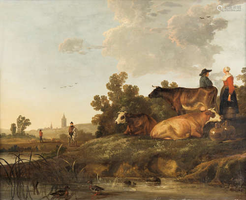 A drover and milkmaid standing beside cattle, a view to a town in the distance Circle of Aelbert Cuyp(Dordrecht 1620-1691)