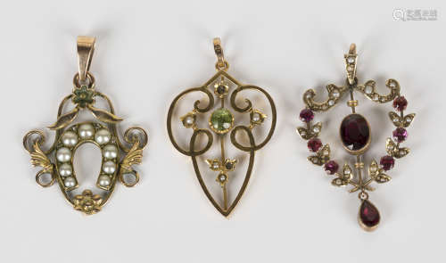 A gold, peridot and seed pearl pendant in a pierced design (two seed pearls lacking), a gold, garnet