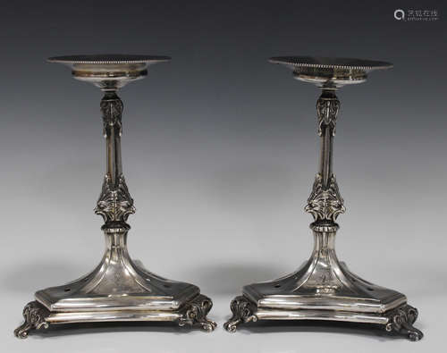 A pair of 19th century Continental white metal centrepiece stands, each circular top on a foliate