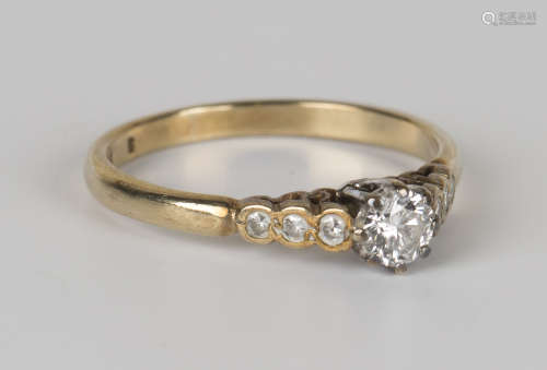A 9ct gold and diamond ring, claw set with the principal circular cut diamond between diamond