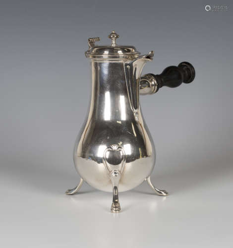 A late 18th century French silver coffee pot of baluster form, the domed hinged lid with turned