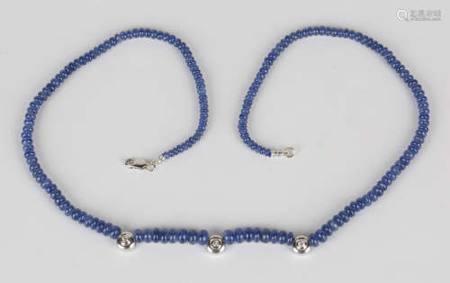 A single row necklace of graduated sapphire beads, the front with three 9ct white gold and diamond