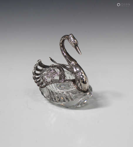 A silver mounted cut glass potpourri jar in the form of a swan with pierced hinged wings, import